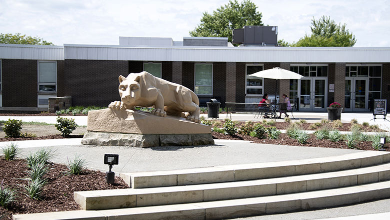 Lion with students sitting in the distance.