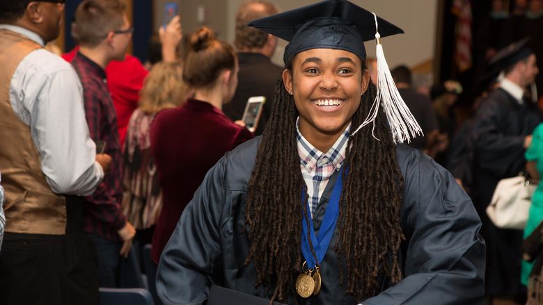 Beaver student Khalia Adams smiles as she walks up the aisle after the commencement ceremony.