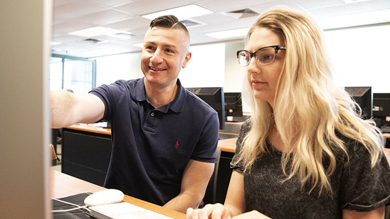 Dr. Aris Karagiorgakis, assistant teaching professor of Psychology, advises 2019 Erickson Discovery Grant recipient Kaylee Aaron. 