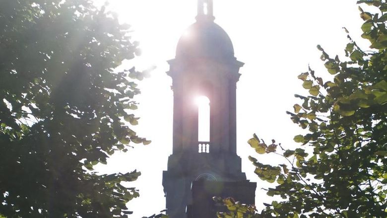 Photo of Old Main with a sun flare