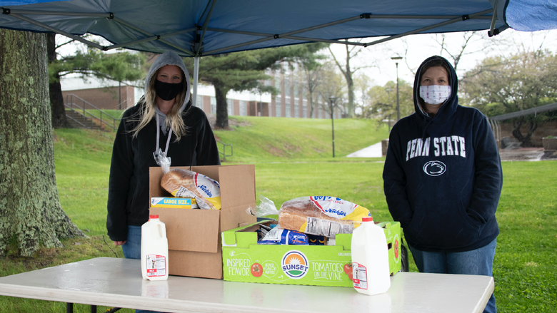 Amanda Collins, mental health counselor, and Ronette Poorbaugh, campus nurse, provide drive-thru donations from the campus food pantry to students in need.